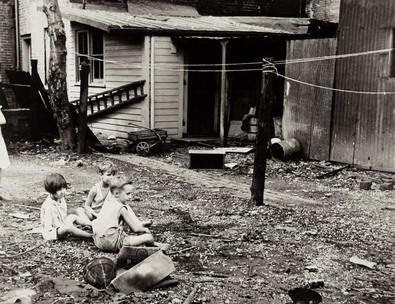 Carl Mydans Children playing in back yard of slum area near