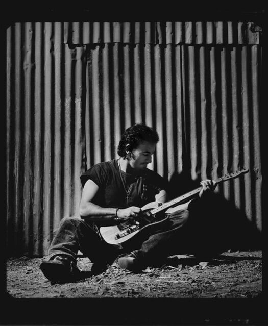 Timothy White | Bruce Springsteen (sitting against a corrogated metal ...