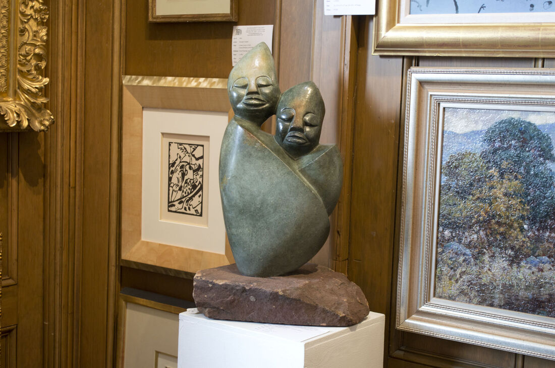 &quot;Together Forever,&quot; opal stone sculpture by Tendai Marowa &amp; Stanley Chideu, Zimbabwe. Wassily Kandinsky woodcut in background. 