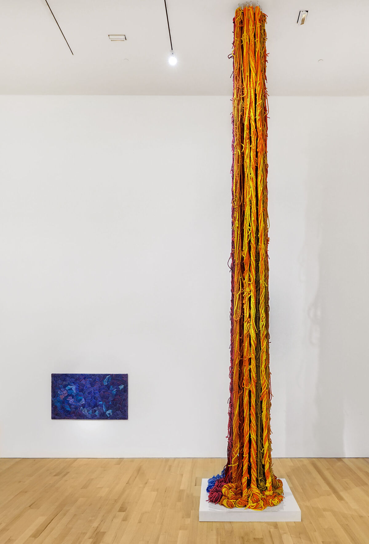 Installation view of Sheila Hicks, Blue Gros Point, ca. 1990, and Questioning Column, 2016, at The Bass, 2019. Photo by Zachary Balber. Courtesy of The Bass, Miami Beach.