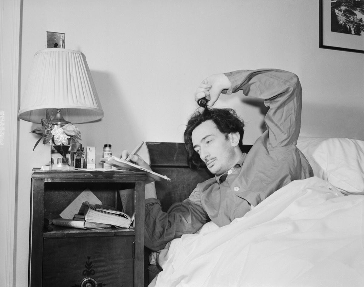 Salvador Dali, surrealist painter, in bed. Photo by Bettmann, via Getty Images.