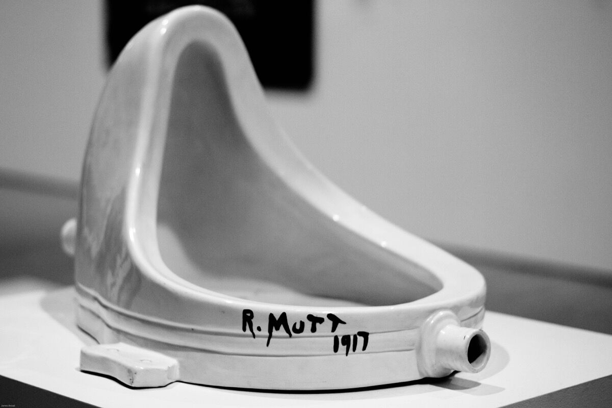 Marcel Duchamp's fountain, 1917, displayed in an art gallery, a leading example of avant-garde art