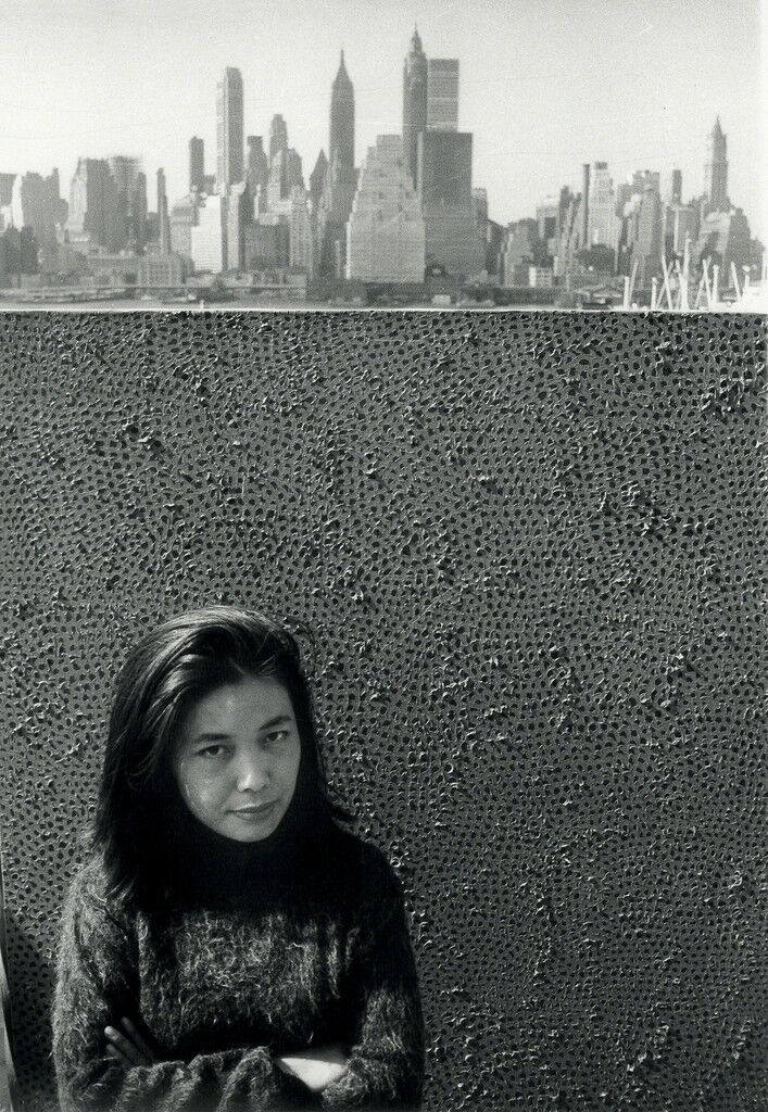 Yayoi Kusama with one of her Infinity Net paintings in New York