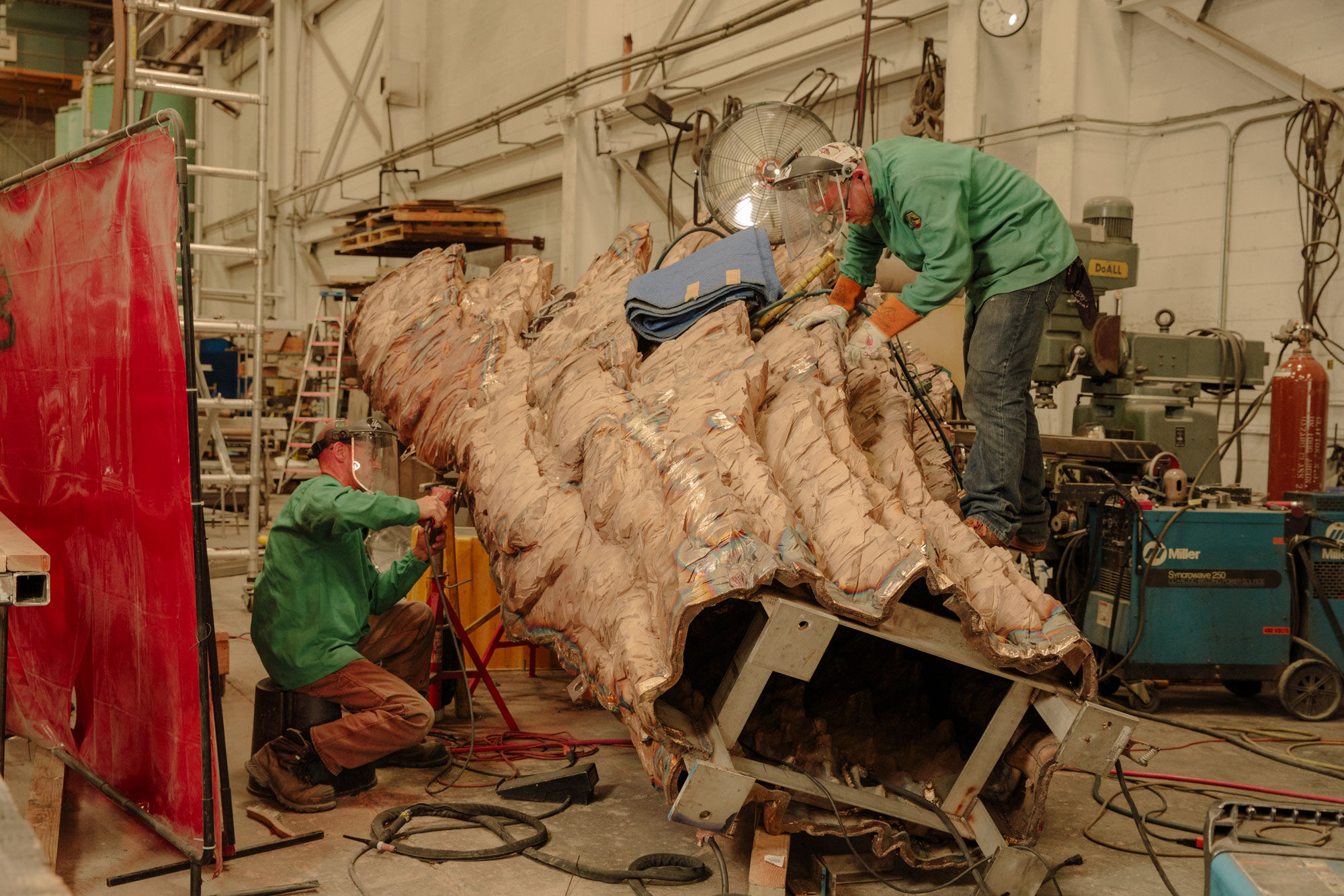 Craftsmen welding and finishing bronze casting for a work by Ursula von Rydingsvard. Photo by Ricky Rhodes for Artsy.