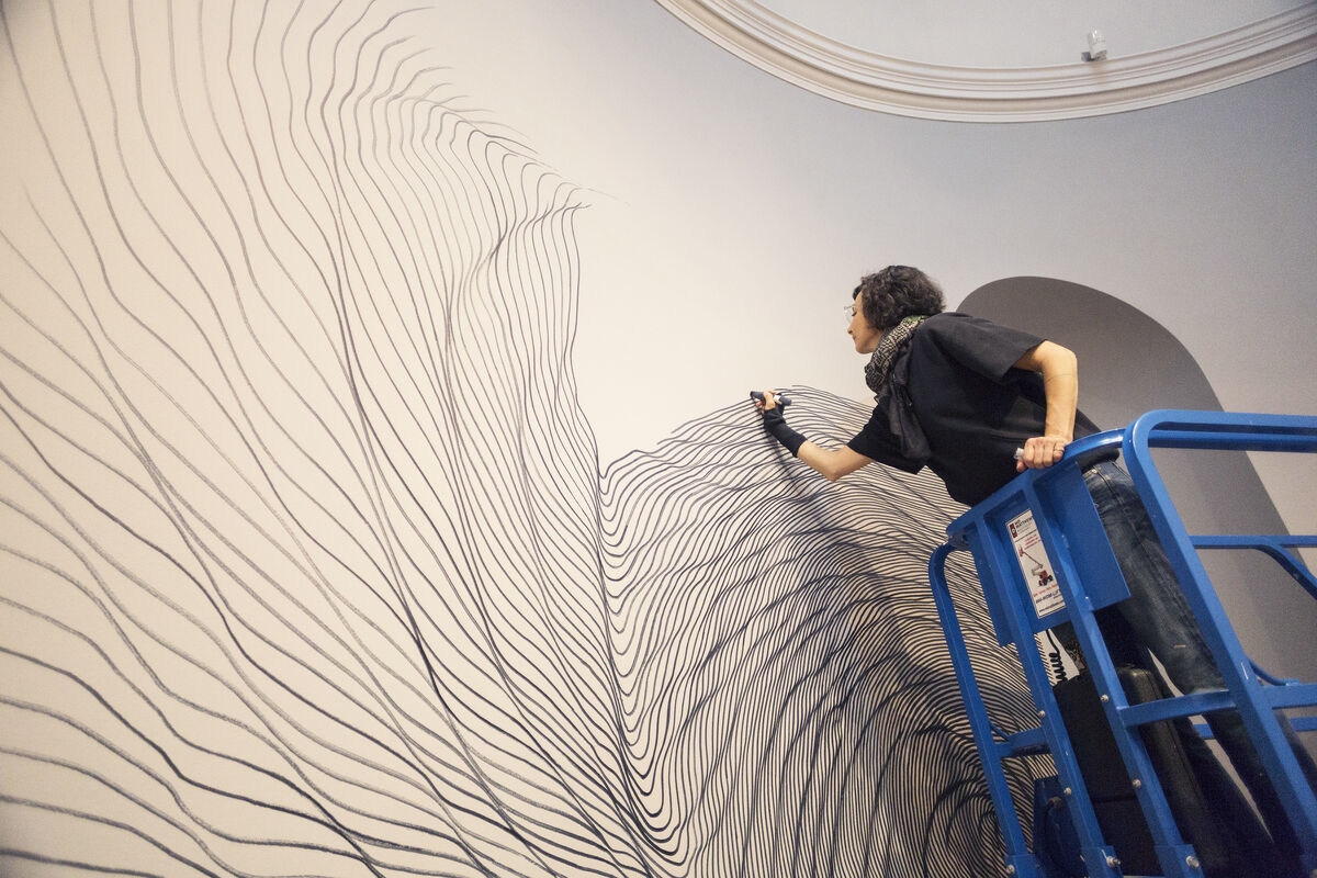 linn meyers working on Let&#x27;s Get Lost, at the Bowdoin College Museum of Art, Brunswick, Maine, 2018. Photo by Dennis Griggs, Tannery Hill Studio, Maine. Courtesy of the Bowdoin College Museum of Art.