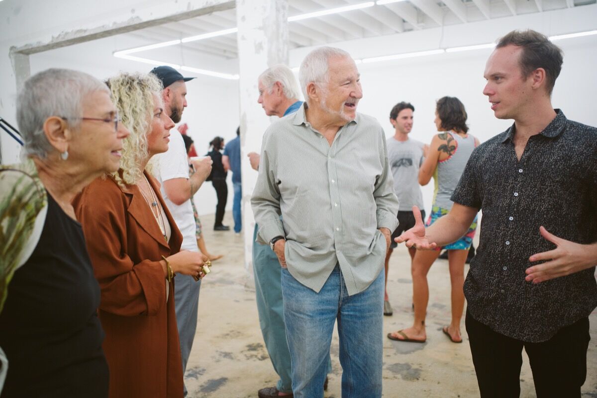 Emmett Moore with guests at the opening of his exhibition &quot;Fractured.&quot; Photo by Gesi Schilling. 