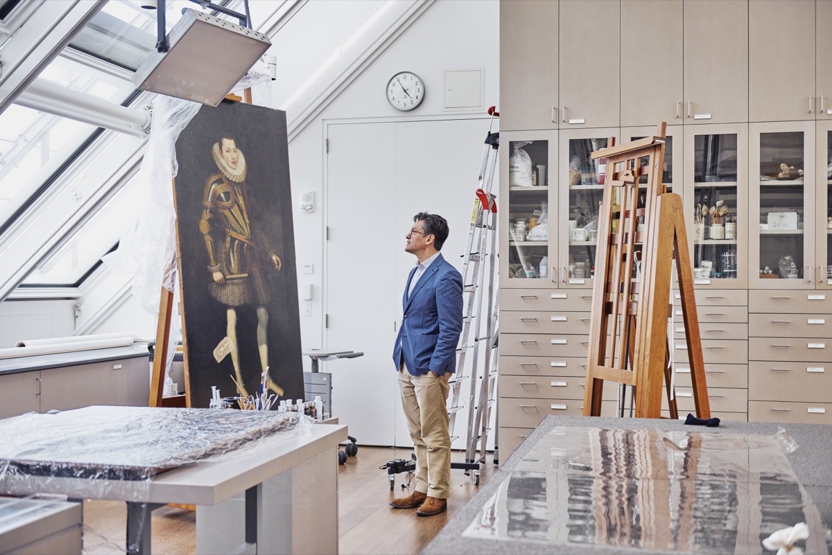 Narayan Khandekar stands in front of a 17th-century Spanish painting that may contain Mummy Brown. Photo by Tony Luong for Artsy.