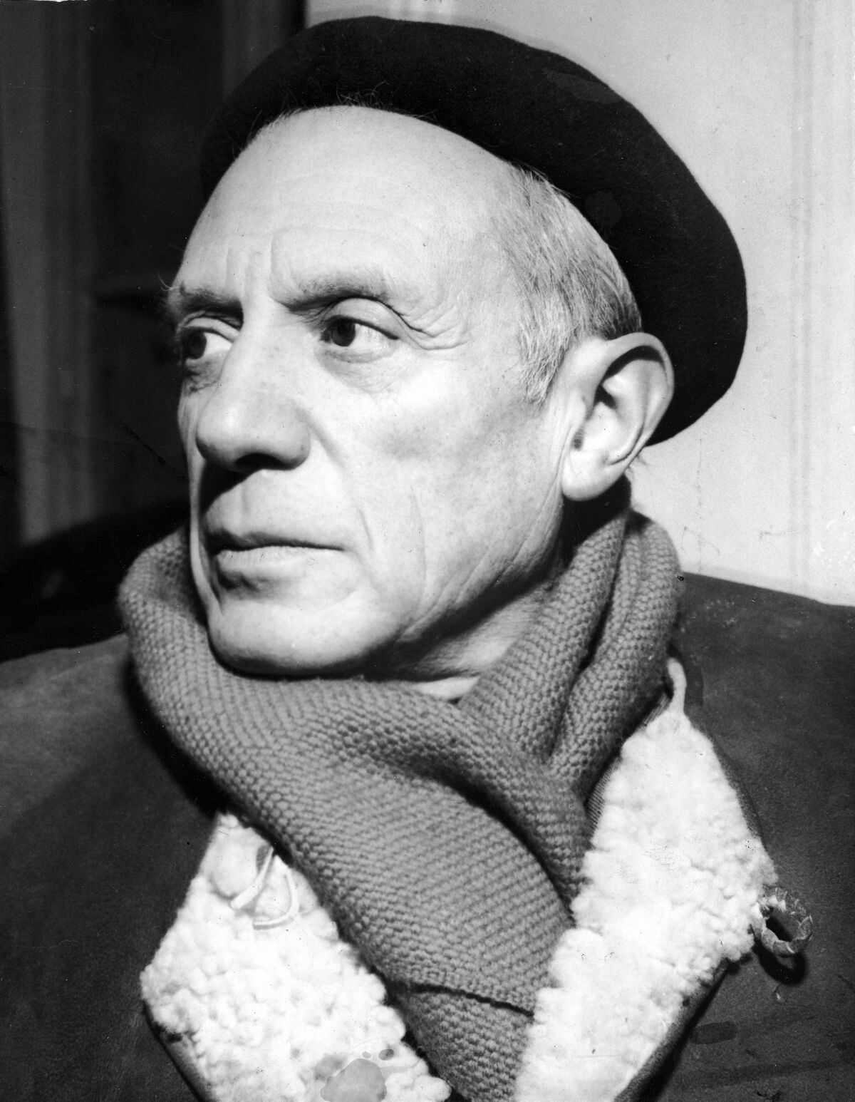 Portrait of Pablo Picasso in a winter coat, scarf, and beret, ca. 1950s. Photo by Hulton Archive/Getty Images.