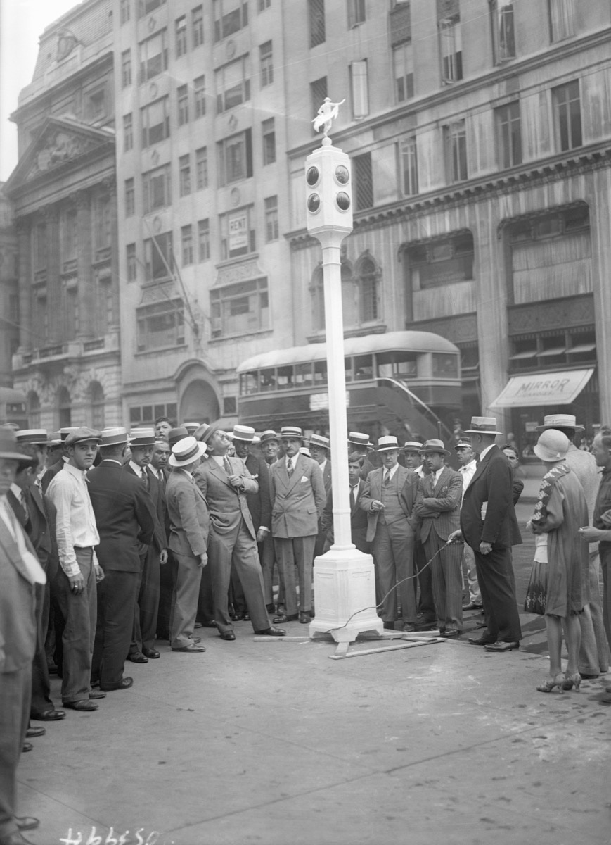 Photo of Commissioner Grover Whalen, along with a crowd of others, examining the new signal posts at 57th Street and 5th Avenue. Photo via Getty Images. 