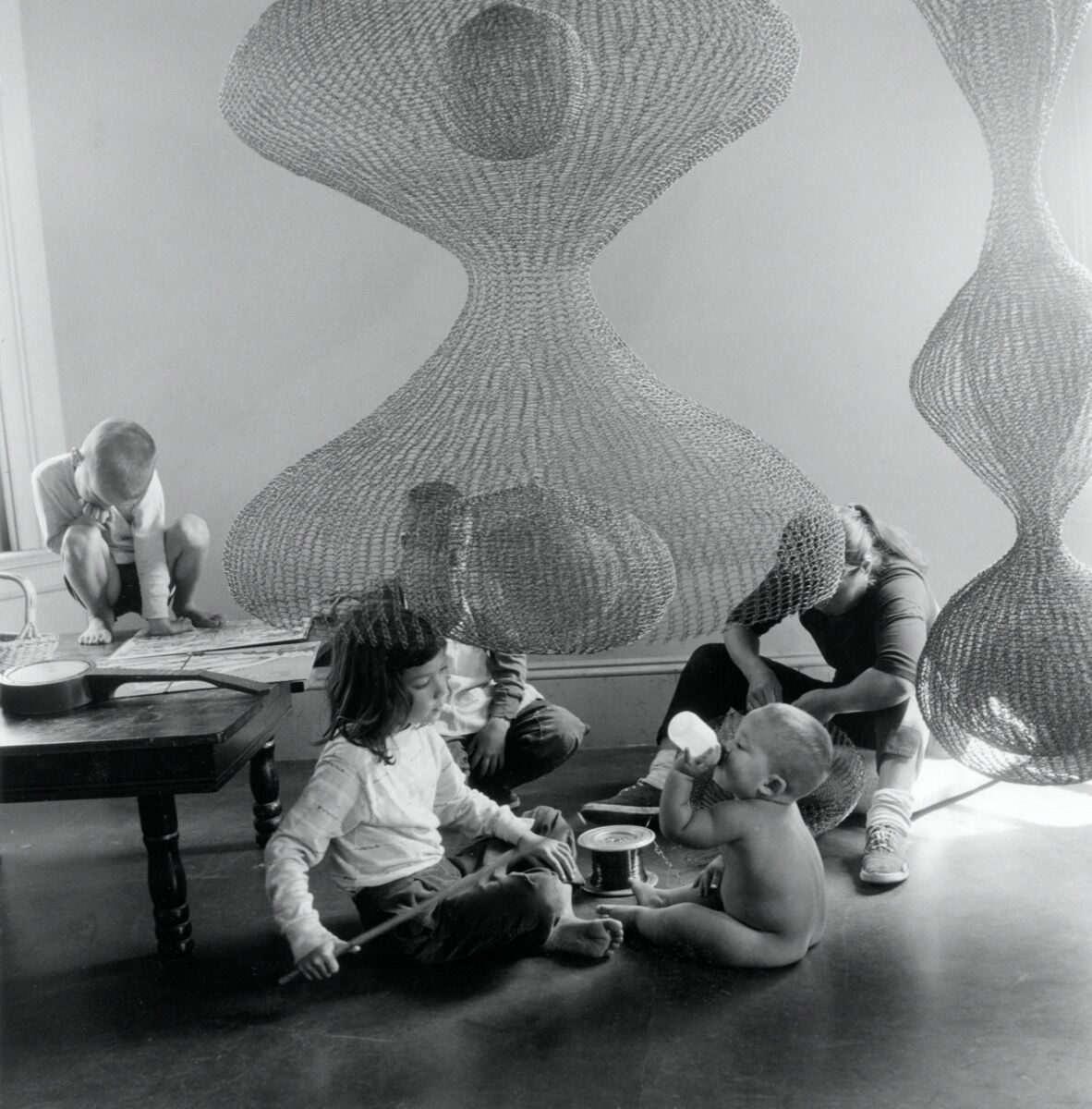 Portrait of Ruth Asawa with her children in her home studio, 1957. Photo by Imogen Cunningham. © 2019 Imogen Cunningham Trust. Courtesy of the Imogen Cunningham Trust.