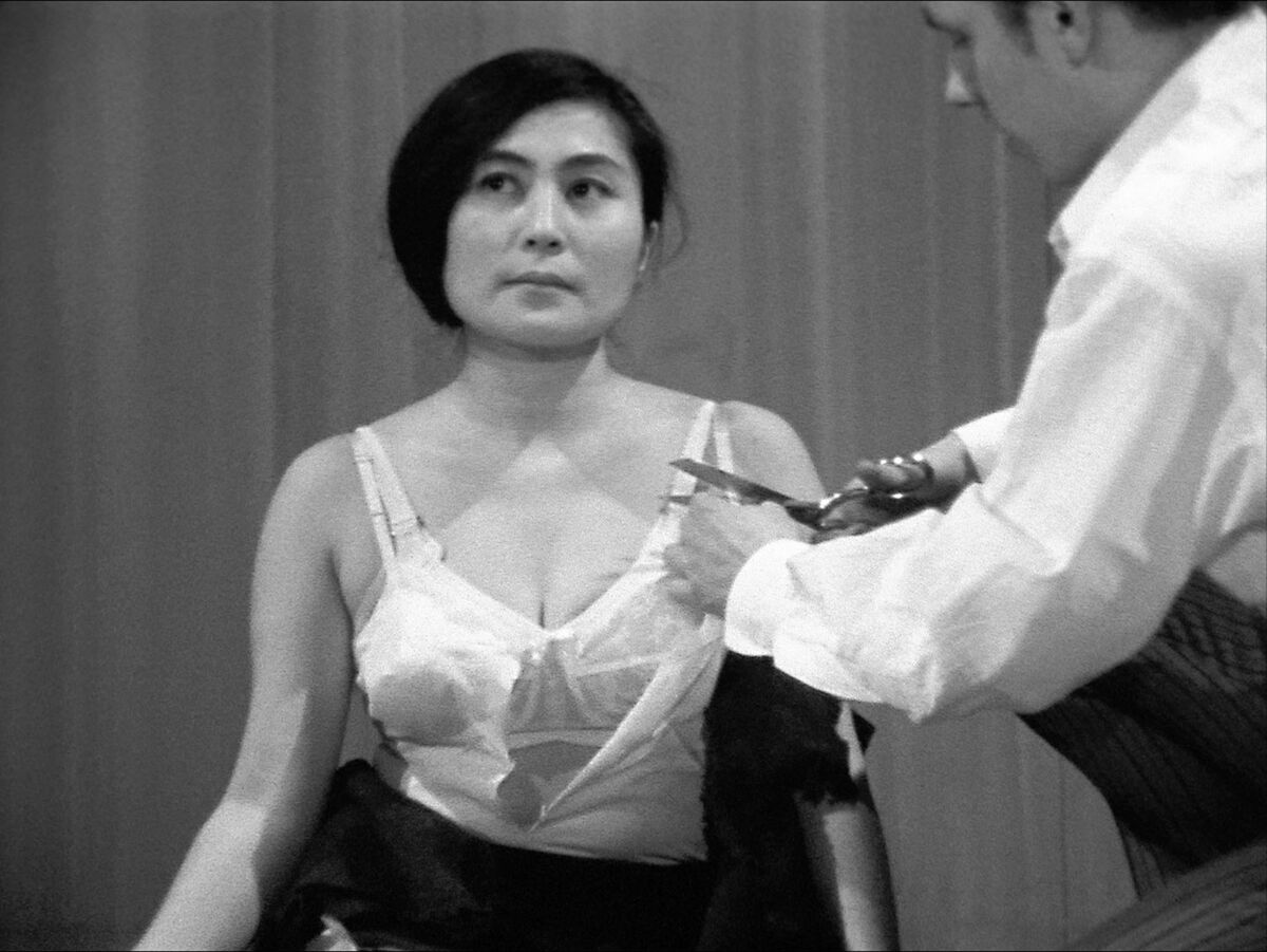 Yoko Ono performing Cut Piece, 1964, filmed by the Maysles Brothers, at Carnegie Recital Hall, March 21, 1965. Image © Yoko Ono. Courtesy of the artist and Galerie Lelong.