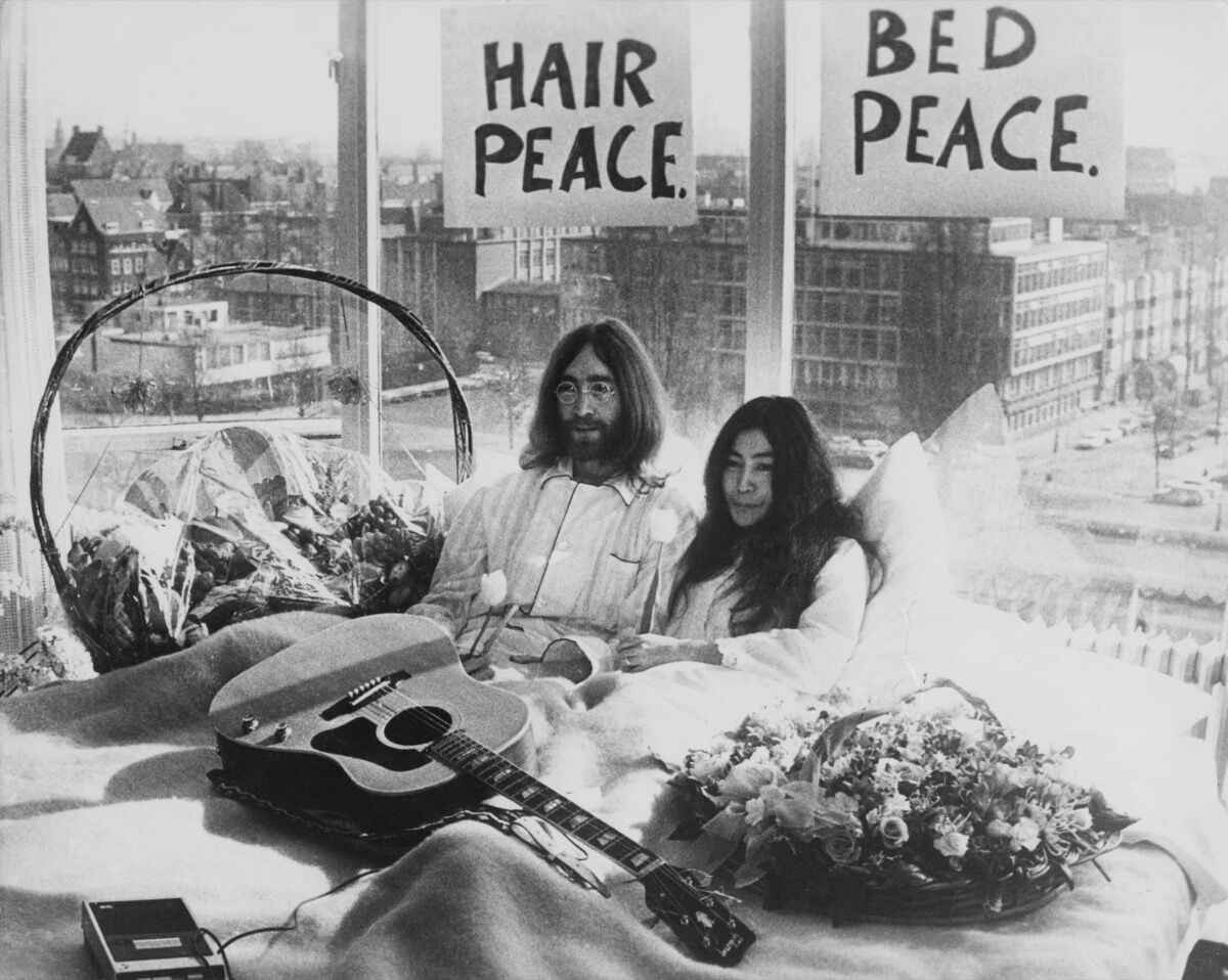 John Lennon and Yoko Ono in their bed in the Presidential Suite of the Hilton Hotel, Amsterdam, 1969. Photo by Keystone/Hulton Archive/Getty Images.