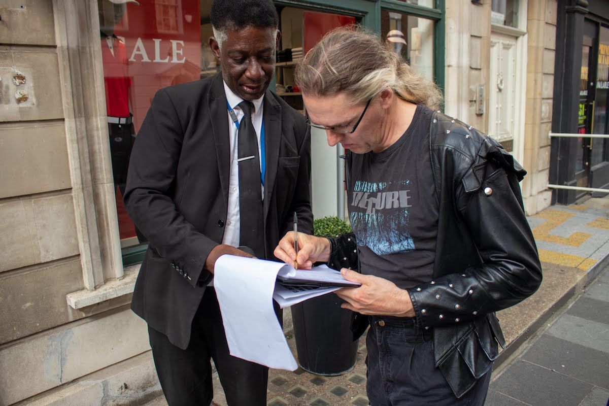 A visitor to the ArtShop signs a document confirming he is not there on behalf of Anish Kapoor. Photo courtesy ArtShop.