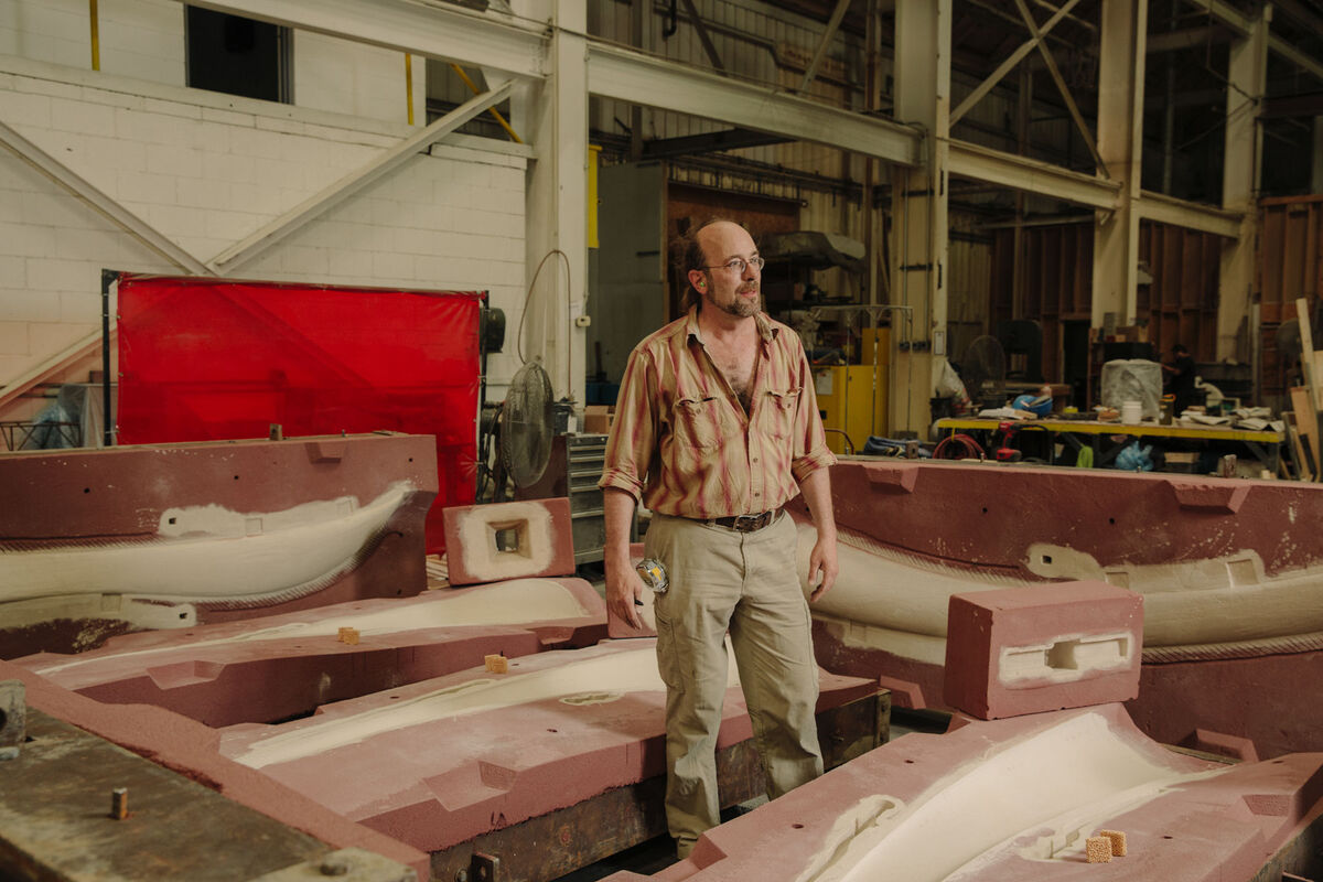 Sand molder Morgan Donahue, surrounded by sand molds for a sculpture by Christopher Curtis.  Photo by Ricky Rhodes for Artsy.