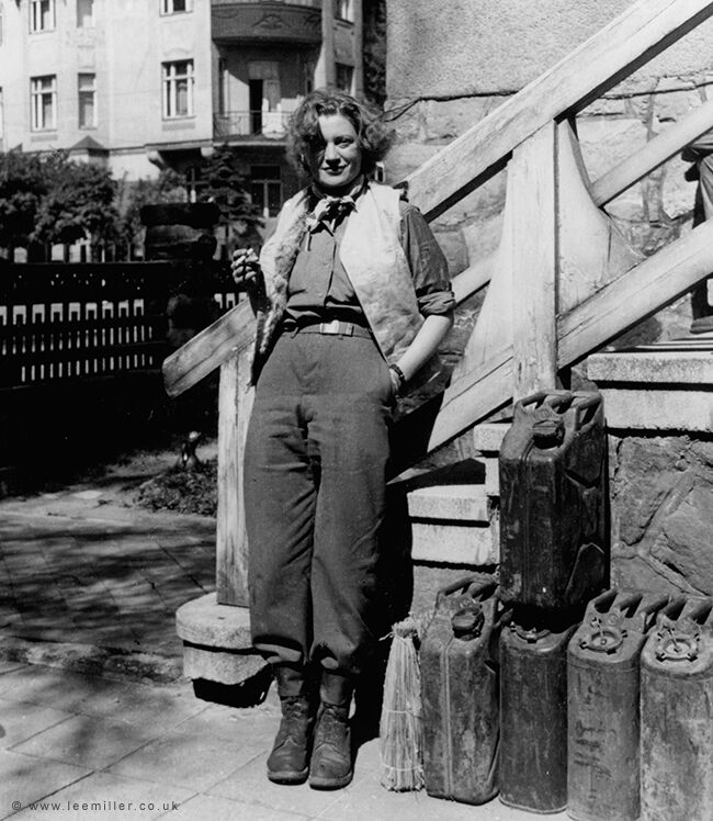 Lee Miller with the essentials of Life, cigarette , wine and petrol , Weimar, by David Sherman