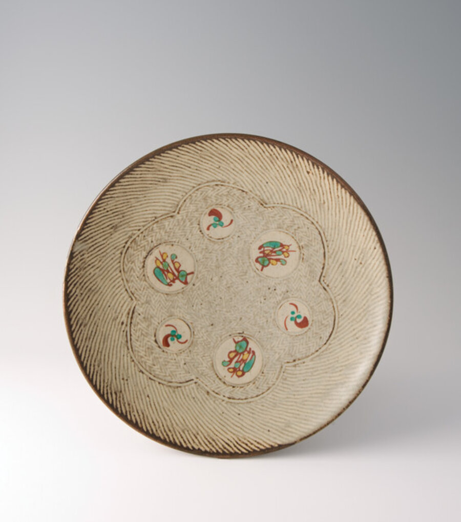 Plate, rope and slip inlay with wax resist overglaze enamel brushwork