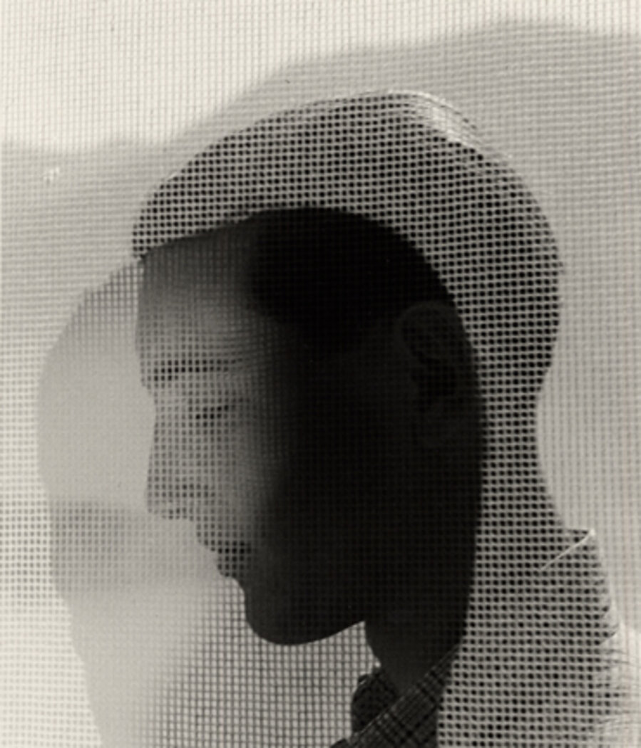 Young man behind curtain, Ascona, Switzerland