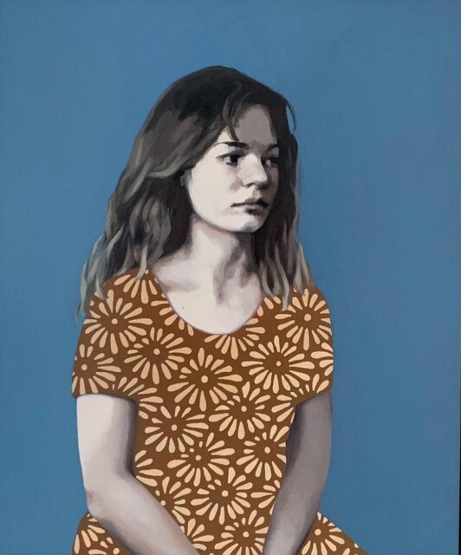 Hester with blue background in a brown dress