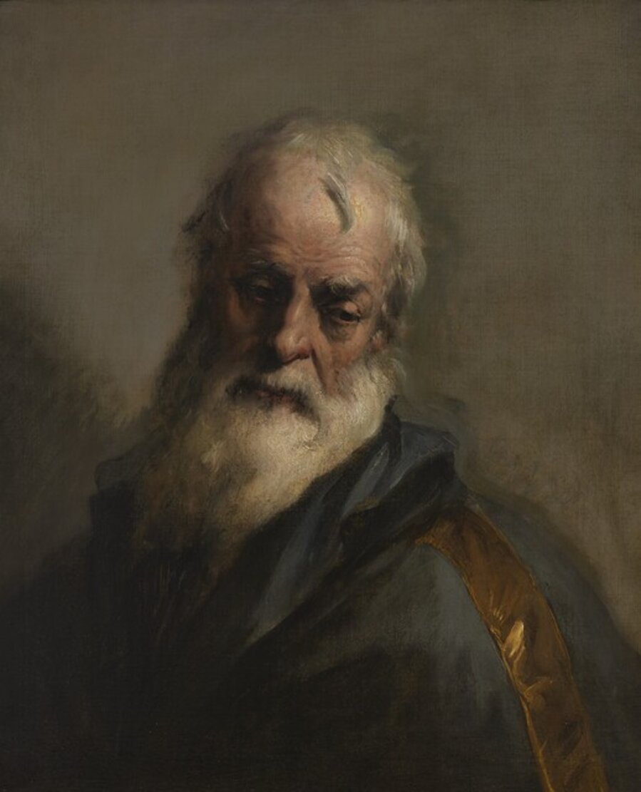 The head of a bearded man looking down