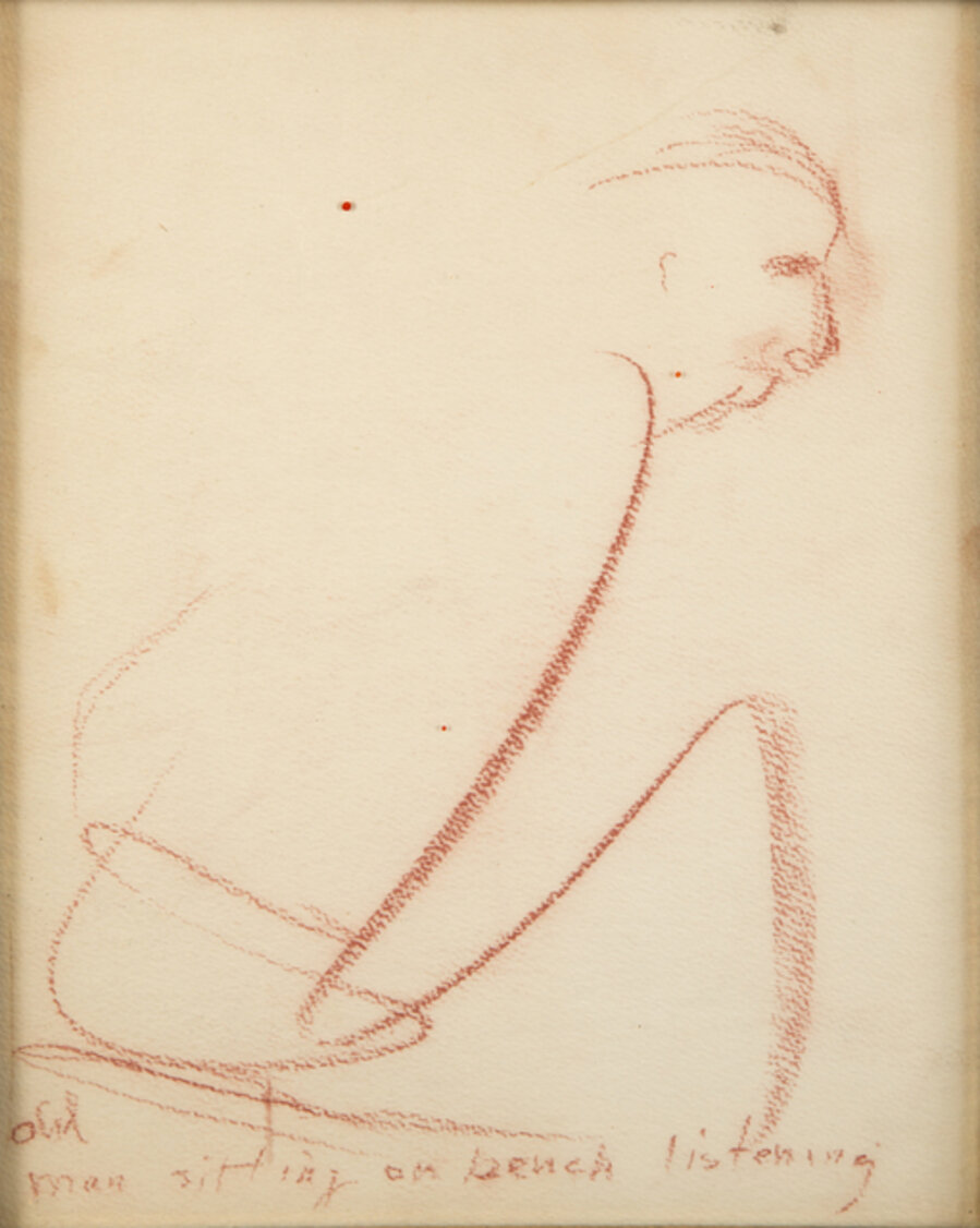 Old man sitting on a bench listening