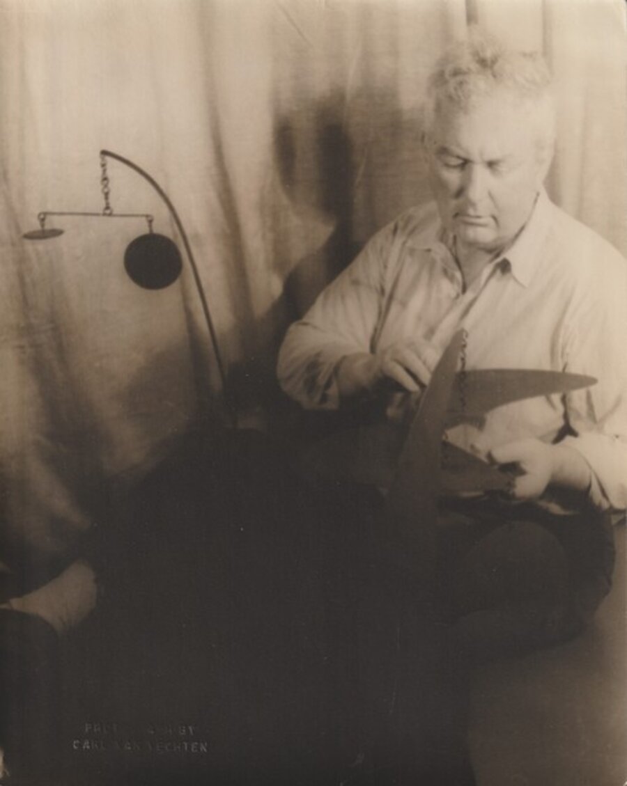 Alexander Calder with his sculpture general Sherman
