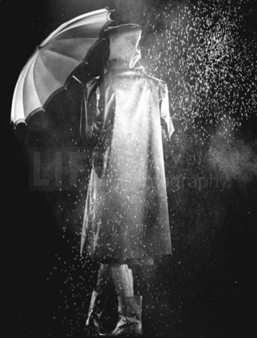 Fashion Shot of Model in Raincoat Holding Umbrella