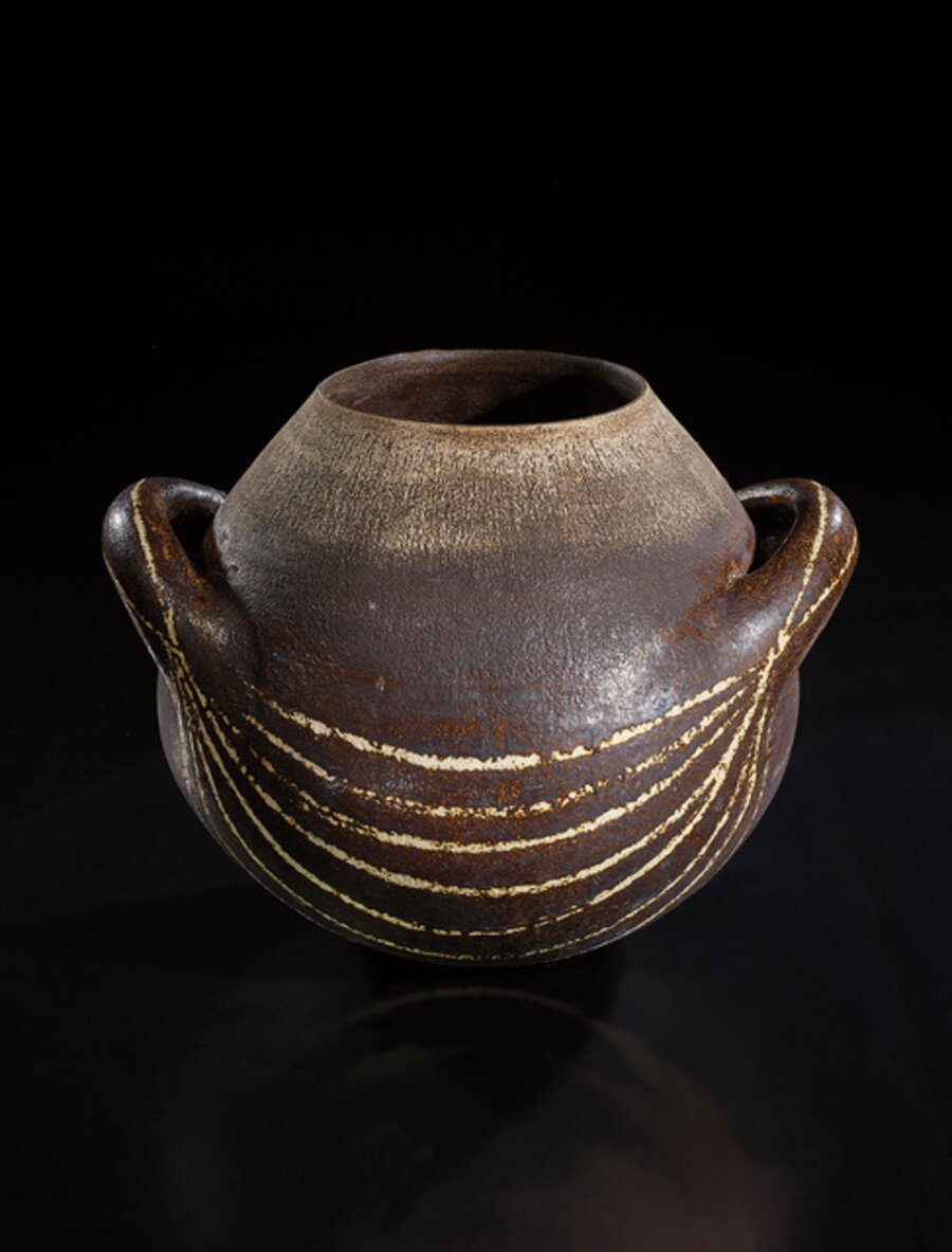 Early and large globular pot with handles and abstract design