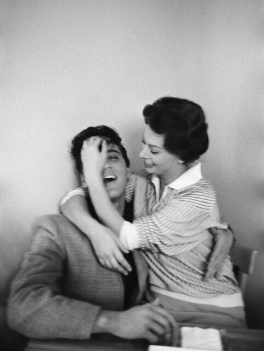 Sophia Loren tussles Elvis Presley’s hair at the Paramount Commissary, Hollywood