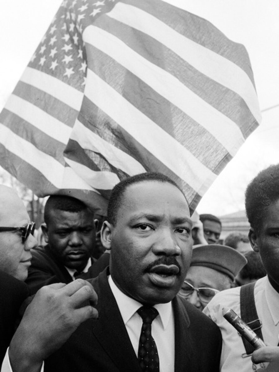 Martin Luther King Jr. leading March with flag, Selma, AL