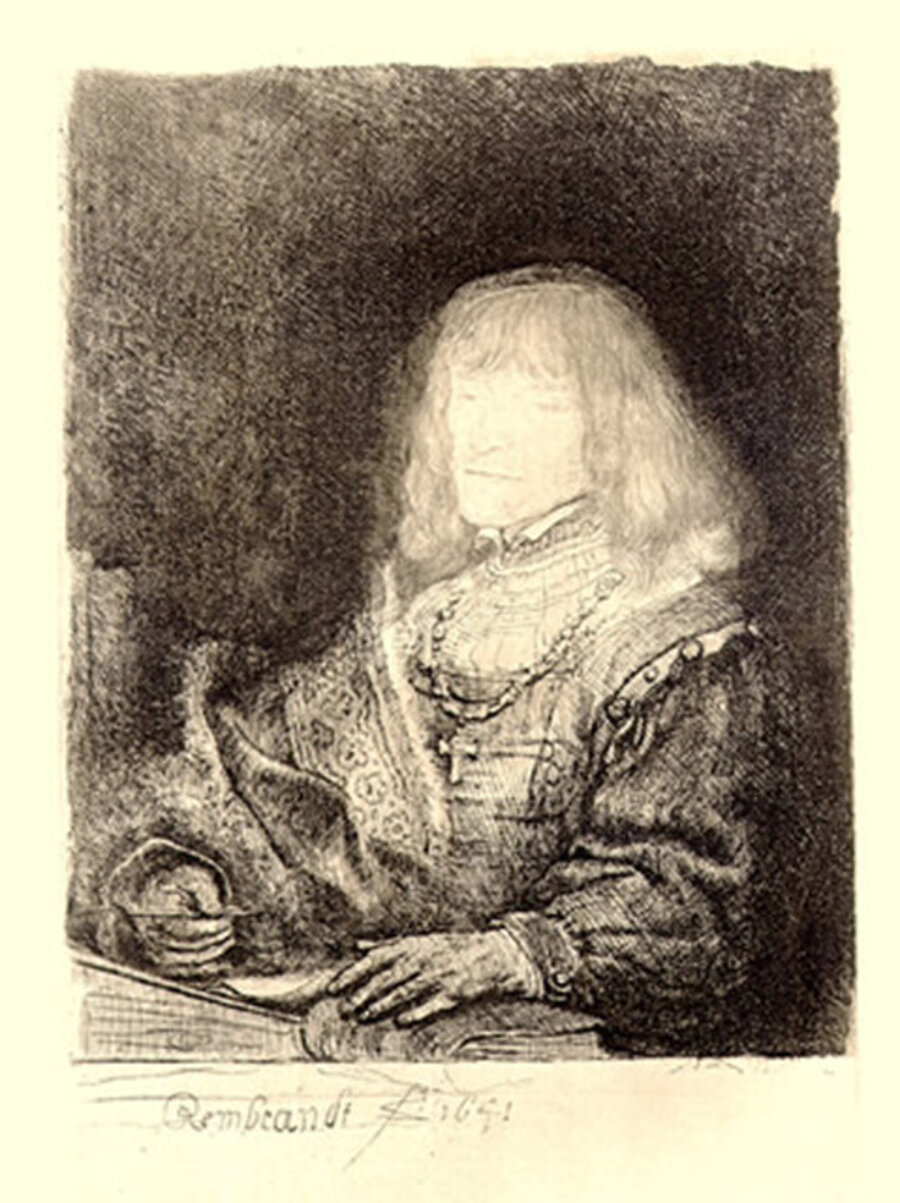 Man at a Desk Wearing a Cross and Chain