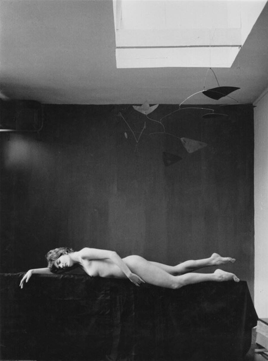Dorothée Blank (1934-2016) lying under a mobile by Calder in Agnès’s studio, rue Daguerre, Paris