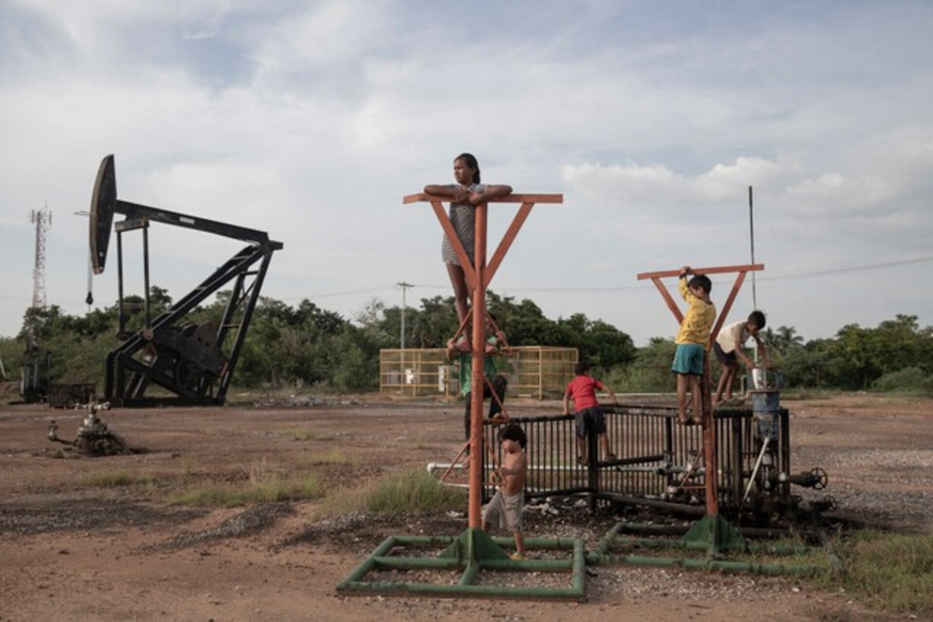 Kids play on top of abandoned oil structure