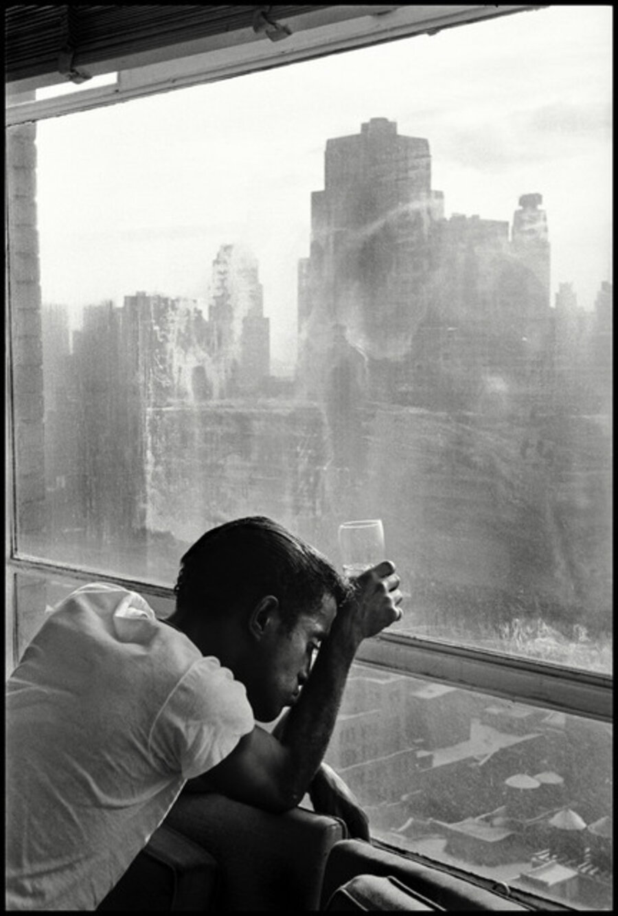 Sammy Davis Junior looks out a Manhattan window. New York, USA
