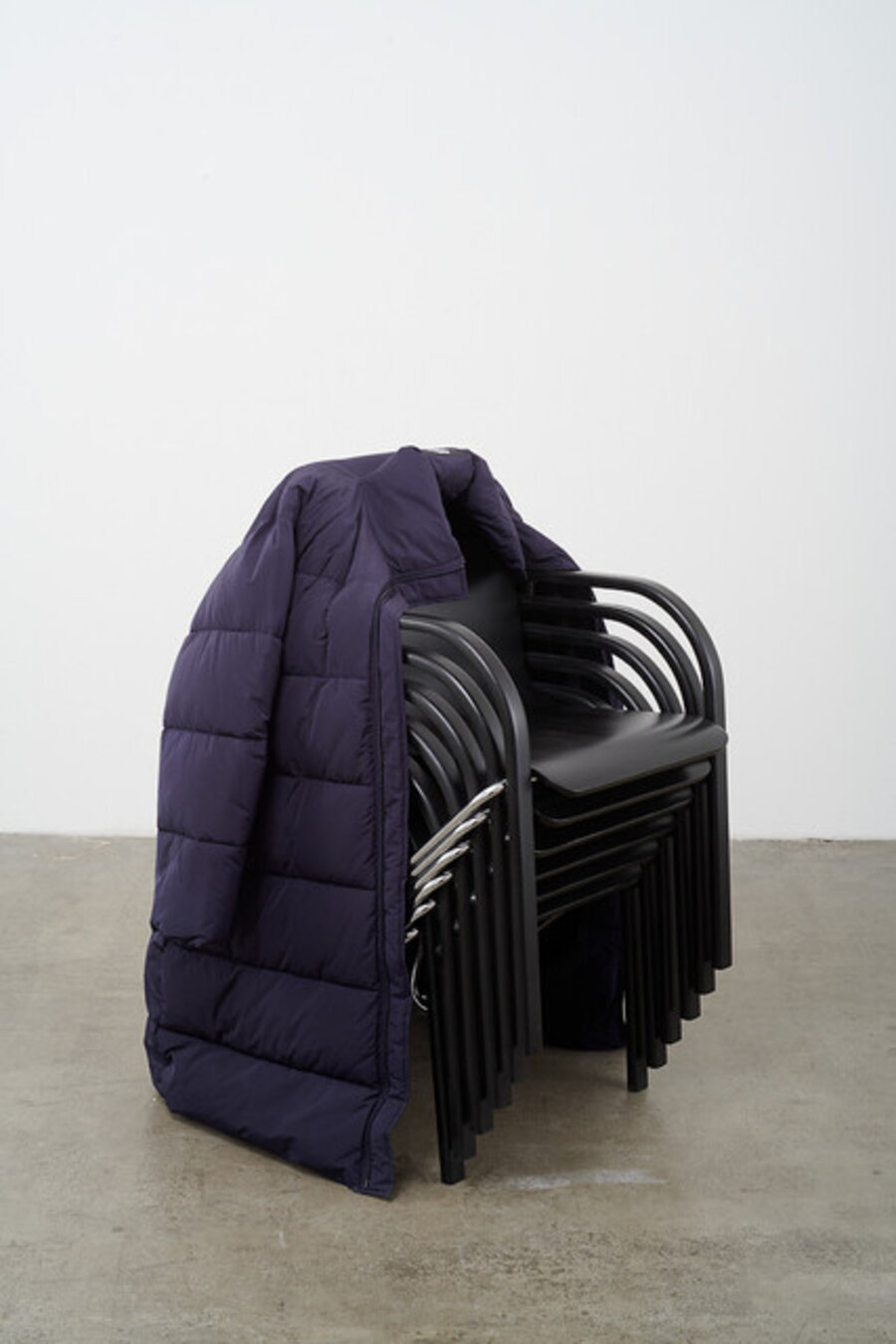 Untitled stack (black/chrome 80s chairs/blue puffa coat)