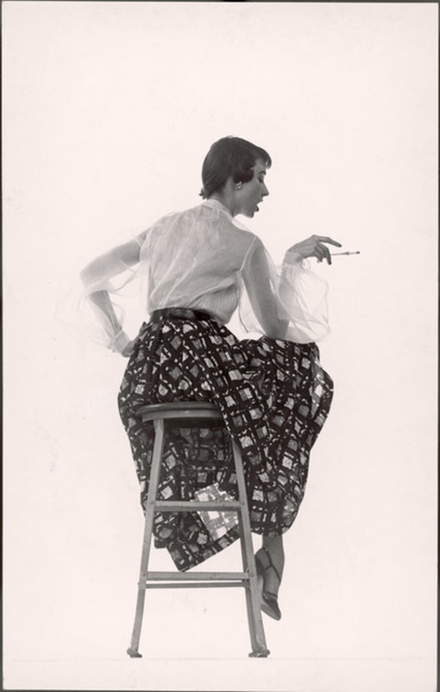 Model Dorian Leigh Wearing White Organdy Shirt with Full Print Skirt by Ceil Chapman (face seen in profile)