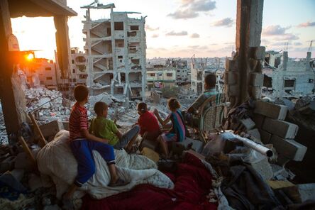 Ann Paq, ‘Palestinian family members sit in their home, which was destroyed during Operation Protective Edge (Tsuk Eitan), in al-Tuffah district in Gaza City. Over 18,000 housing units were destroyed or damaged, and 2,000 Palestinians were killed during 50 days. September, 2014’, 2014