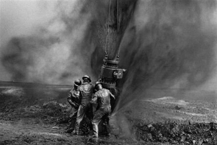 Sebastião Salgado, ‘Workers struggle to remove bolts from the remains of an old wellhead. Working with metal tools can produce sparks, threatening to consume everything in flames, Oil Wells, Greater Burhan, Kuwait’, 1991