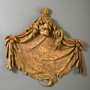 William Kent, ‘A PAIR OF GEORGE II CARVED GILTWOOD LION’S PELT OVERDOORS, IN THE MANNER OF WILLIAM KENT’, ca. 1740