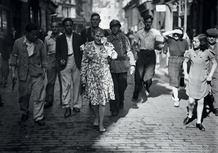 AFP, ‘A French woman accused of collaborating with the German occupiers, is forced to parade in the streets of Paris, on August 20th, 1944, barefoot, shaved off and with a swastika painted on her face.’, 1944