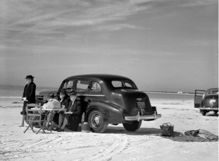 Marion Post Wolcott, ‘“Get the Party Started” Winter Visitors from Nearby Trailer Park, Picnicking Beside Car on Beach, Near Sarasota, Florida’, 1941