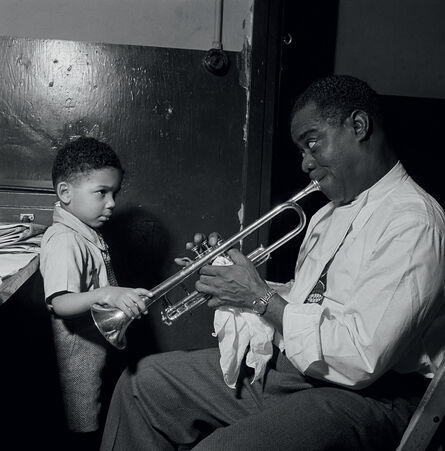 AFP, ‘Louis Armstrong plays in his dressing room for a little boy before performing in a jazz cabaret in New York in 1947.’, 1947