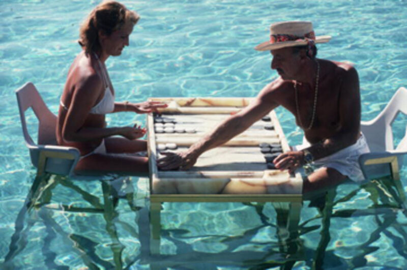 Slim Aarons, ‘Keep your Cool, 1978: Carmen Alvarez enjoying a game of backgammon with Frank Brandstetter in a swimming pool in Acapulco, Mexico ’, 1978, Photography, C-Print, Staley-Wise Gallery