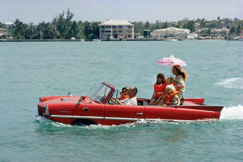 Slim Aarons, ‘Sea Drive, 1967: Film producer Kevin McClory takes his wife Bobo Segrist and their family for a drive in an “Amphicar” across the harbour at Nassau, Bahamas’, 1967, Photography, C-Print, Staley-Wise Gallery