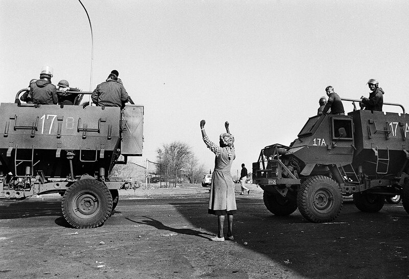 Paul Weinberg, ‘A lone woman protests as the soldiers occupying her township roll by in large military vehicles called, “hippos”, Soweto, 1985’, 1985, Photography, Silver gelatin print, Goodman Gallery