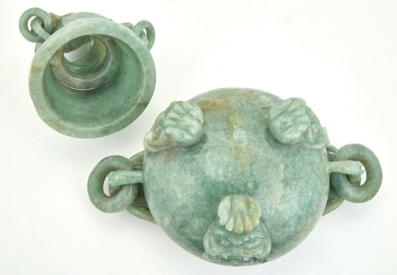 ‘Chinese Hardstone Covered Censer’, Design/Decorative Art, The compressed bombé body resting on three cabriole legs issuing from lion masks, the body flanked by a pair of dragon head handles suspending loose rings, the domed lid with three animal mask handles suspending loose rings and surmounted by a coiled dragon finial, the stone of a pale variegated celadon and apple green color., Doyle