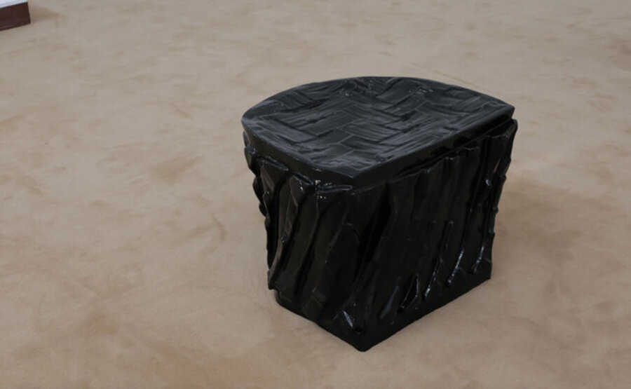 A black cast of the space under my chair