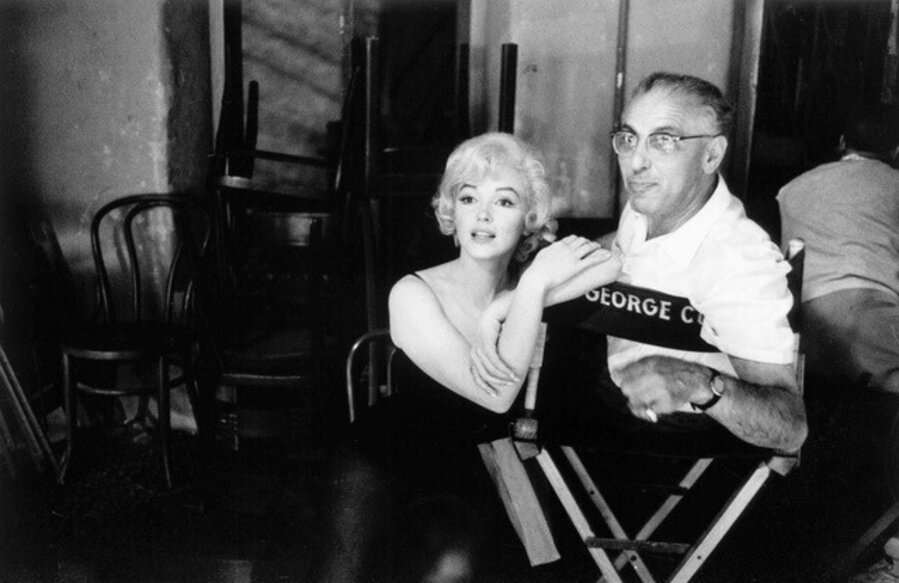 Marilyn Monroe and director George Cukor chat on the set of "Let’s Make Love"