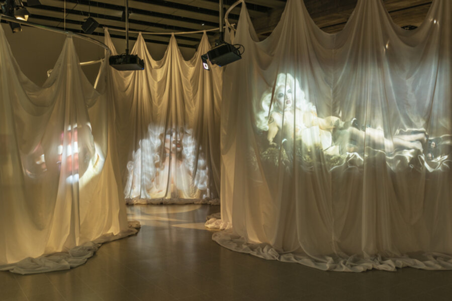 A View from Elsewhere, Act 1, She Postures in Context