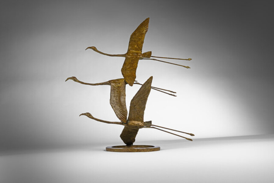Three Flamingos in Flight