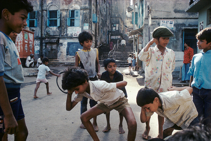 Playing 'Punishment', a marble game, Bombay